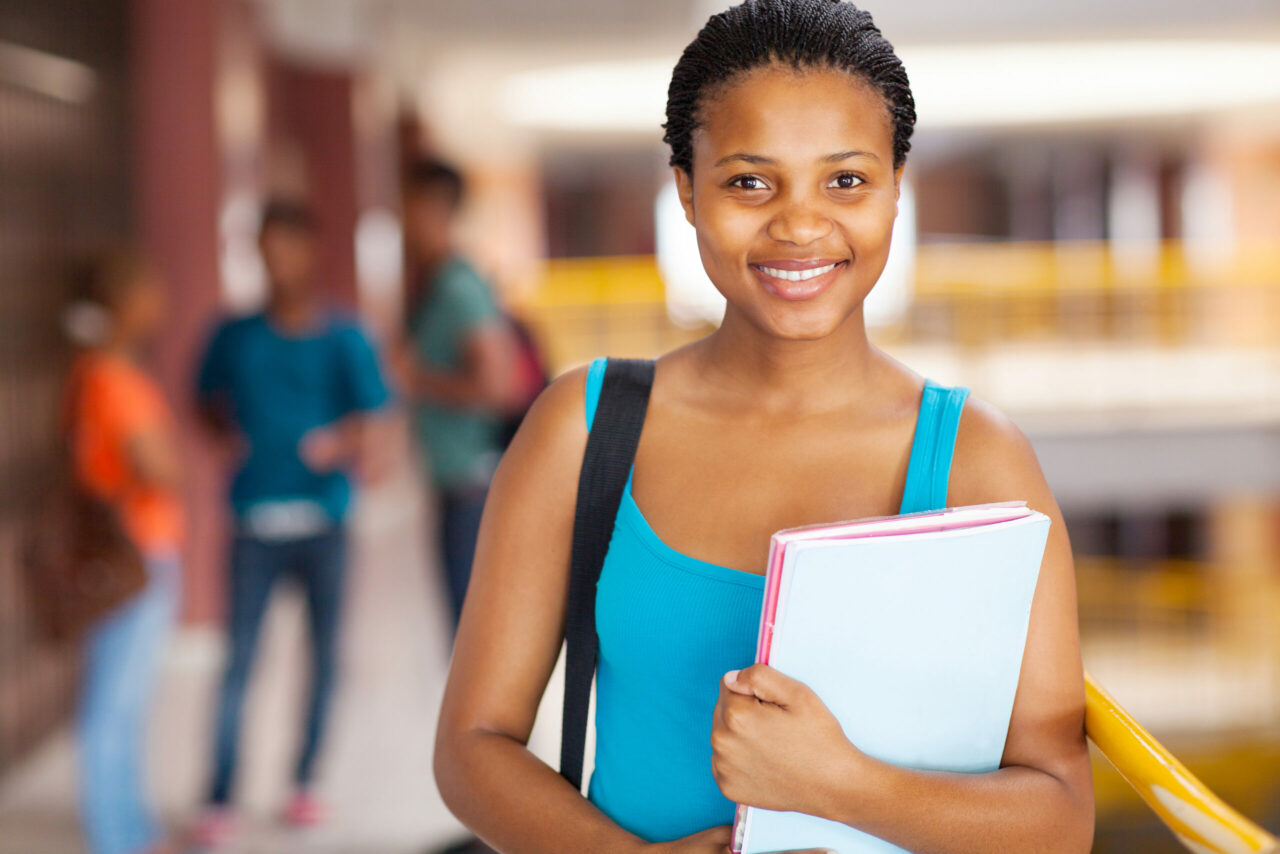 happy student holding high school transcript